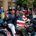 M.V. Solvberg, right, who is a member of the Vietnam Veterans of America, and Marty Cothorn, the president of Vietnam Veterans of America Washtenaw County Chapter 310, wave from a three-wheeled motorcycle during the Ypsilanti Fourth of July parade on Cross St. Angela J. Cesere | AnnArbor.com