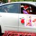 Silvia Hood, the Queen Mother of the Kwanzaa's Imperial Soul Sisters Red Hat Society waves from her car during the Ypsilanti Fourth of July parade. Angela J. Cesere | AnnArbor.com