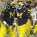 Junior defensive tackle William Campbell, left, and senior defensive end Ryan Van Bergen celebrate with junior safety Brandin Hawthorne after they stopped a play during the football game against Notre Dame on Sept. 10, 2011. Angela J. Cesere | AnnArbor.com