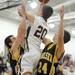 Chelsea's Cody Barber, left, and Zach Rabbitt, right, try to block a shot by Dexter's JAcob VanHoof. Angela J. Cesere