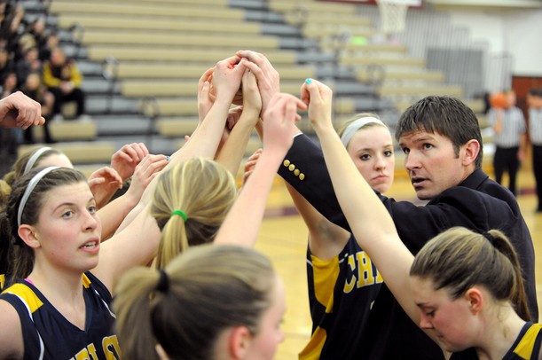 Chelsea head coach Todd Blomquist and team put their hands in to get fired up after a timeout.  Angela J. Cesere