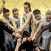 The Dexter girls basketball team puts their hands in after a time-out. Angela J. Cesere