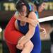 Virginia girls wrestling team member Taylor Caufield, center (blue), picks Wisconsin girls wrestling team member Callie Peyton up by the leg during a high school age bracket wrestling match at the United States Girls' Wrestling Association National Championships inside Bowen Field House at Eastern Michigan University on Saturday afternoon. Each state's team is composed of the top female wrestlers in that state, with ages ranging from kindergarten to high school. Angela J. Cesere | AnnArbor.com
