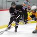 Saline defenseman Joe Colarossi, right, tries to grab the puck from Pioneer forward Robert Bondy during the regional playoff game at the Ann Arbor Ice Cube on Wednesday evening. Pioneer defeated Saline 5 - 4. Angela J. Cesere | AnnArbor.com
