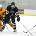 Saline forwards Tyler Gross, left, and Antonio Diaz, right, try to take the puck from Pioneer forward Tommy Pokorney.  Angela J. Cesere | AnnArbor.com
