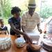 6-year-old Askia Rahman, left, watches as his sister Saidah, age 13, center, and father Ahmad, center right, pick out a cake after winning during the cake walk at the Juneteenth celebration.  Angela J. Cesere | AnnArbor.com
