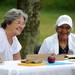Ann Arbor NAACP Vice President Joseph Mhoon, right, and NAACP board member Ruth Zweifler, left, share a laugh during the 18th annual Juneteenth Celebration at Wheeler Park. Angela J. Cesere | AnnArbor.com