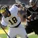 Bellarmine's Ross Doan tries to knock Michigan's Brian Greiner off balance to get the ball.  Angela J. Cesere | AnnArbor.com
