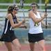 Pioneer's Sydney Reinholt, left, tries to take the ball away from Huron's Anna Masini during the lacrosse quarter finals game against Huron. Angela J. Cesere | AnnArbor.com