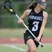 Pioneer's Sophie Buchmueller looks for a pass down the field during the lacrosse quarter finals game against Huron. Angela J. Cesere | AnnArbor.com