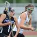Huron's Taylor Standiford, right, chases down Pioneer's Andrea Reyes during the lacrosse quarter finals game at South Lyon High School. Angela J. Cesere | AnnArbor.com