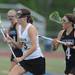 Pioneer's Mercedes Reyes, right, runs after Huron's Kelsey Aaronson, during the lacrosse quarter finals game at South Lyon High School. Angela J. Cesere | AnnArbor.com