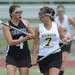 Pioneer's Mercedes Reyes, left, tries to block Huron's Mariel Ward from progressing down the field during the lacrosse quarter finals game at South Lyon High School. Angela J. Cesere | AnnArbor.com
