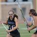 Huron's Kelsey Gradwohl, right, tries to block the path of Pioneer's Stephanie Terrell during the lacrosse quarter finals game at South Lyon High School. Angela J. Cesere | AnnArbor.com 