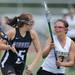 Huron's Kelsey Gradwohl, right, blocks Pioneer's Nicole Derderian from moving toward the goal during the lacrosse quarter finals game at South Lyon High School. Angela J. Cesere | AnnArbor.com 
