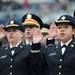 University of Michigan Army ROTC graduates Lisa Chen, right, and Arin Heinz raise their hands during the commissioning ceremony at commencement. Angela J. Cesere | AnnArbor.com