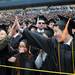 University of Michigan recent graduate Teeruth Thungkasemvathana, right, high fives Nanthakan Rassamirama at the end of the commencement ceremony. Angela J. Cesere | AnnArbor.com