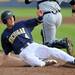 Michigan freshman Will Drake slides into home plate after a hit by sophomore John DiLaura. Angela J. Cesere | AnnArbor.com
