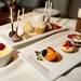 A display tray of Melange's dessert offerings including (clockwise from left) creme brulee, assorted cake balls, cupcakes, the Chocolate Devastation, turtle cheesecake, New York style cheesecake, and a fruit tart.  Angela J. Cesere | AnnArbor.com
