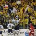 Michigan forward Chris Brown jumps up on the glass after scoring the first goal of the game against Miami of Ohio on his birthday. Fans cheered, holding up signs and Texas flags, which is where Brown is from. Angela J. Cesere | AnnArbor.com
