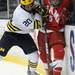 Michigan forward Travis Lynch wrestles for the puck with Miami of Ohio defenseman Cameron Schilling. Angela J. Cesere | AnnArbor.com
