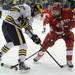 Michigan forward Alex Guptill fights for the puck with Miami of Ohio defenseman Steven Spinell. Angela J. Cesere | AnnArbor.com