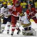 Michigan goalie Shawn Hunwick, right, grabs the puck from Miami of Ohio forward Tyler Biggs. Angela J. Cesere | AnnArbor.com
