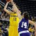 Michigan guard Kate Thompson, left, takes a shot while Northwestern guard Meghan McKeown tries to block her.  Angela J. Cesere | AnnArbor.com
