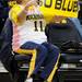 Ann Arbor resident Karen Kostamo moves her feet and waves a banner to music during the game. Angela J. Cesere | AnnArbor.com
