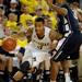 Michigan guard Trey Burke dribbles past Penn State guard Trey Lewis, right. Angela J. Cesere | AnnArbor.com