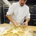 After rolling out the dough, Jerry cuts out round pieces of dough. Angela J. Cesere | AnnArbor.com