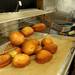 Paczki being emptied back onto the cookie sheet from the fryer. Angela J. Cesere | AnnArbor.com