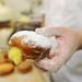 A finished paczki, held by Weber's production baker Jerry Alcenius. Angela J. Cesere | AnnArbor.com