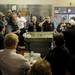 A group of people gather in the kitchen of the Parthenon to participate in the auctioning off of equipment. Angela J. Cesere | AnnArbor.com
