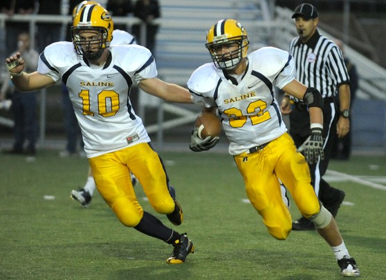 Saline tight end Joey Wooley, left, blocks for the running back Joel Strobbe as he runs with the ball during the football game against Pioneer at Pioneer High School on Sept. 16, 2011. Angela J. Cesere | AnnArbor.com