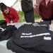 Fancy Stitch employee Melissa Vitale, left, checks the order form for Dexter tornado t-shirts, which are printed by Fancy Stitch, outside of the store on Dexter Chelsea Rd. on Saturday morning. Proceeds from the shirt sales go to help the Dexter area fire department. Angela J. Cesere | AnnArbor.com
