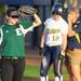 From left: EMU first baseman Amanda Herron blocks the sun from her face as MIchigan third baseman Stephanie Kirkpatrick listens to associate head coach Bonnie Tholl. Angela J. Cesere | AnnArbor.com
