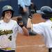 Michigan infielder Taylor Hasselbach, left, high fives teammate Lyndsay Doyle after Hasselbach reached home base after hitting a double. Angela J. Cesere | AnnArbor.com
