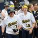 Outfielder Nicole Sappingfield, (15), and all the Michigan teammates ran out to home plate to congratulate Amanda Chidester (3), center left, on her home run that put the mercy rule into effect and ended the first of two games against Penn State Saturday afternoon. The final score was 11 - 2.  Angela J. Cesere | AnnArbor.com

