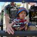 Pittsfield resident Kevin Mount holds his 16-month-old son, Alexander, up for a drink on South University at Ann Arbor's South University Art Fair.  Angela J. Cesere | AnnArbor.com 
