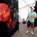 Ann Arbor resident Jimmy Halt looks at the painted stainless steel sculptures of artist Rommel Ricaurte on South University at Ann Arbor's South University Art Fair. Angela J. Cesere | AnnArbor.com 