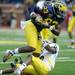 Junior wide receiver Jerald Robinson catches a pass while junior Courtney Avery tries to tackle him. Angela J. Cesere | AnnArbor.com
