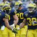 Michigan sophomore running back Thomas Rawls slaps hands with junior wide receiver Drew Dileo after Rawls scored a touchdown.  Angela J. Cesere | AnnArbor.com
