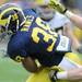 Junior linebacker Jake Ryan, right, reaches to tackle sophomore running back Thomas Rawls as he runs down the field with the ball.  Angela J. Cesere | AnnArbor.com
