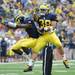 Michigan junior quarter back Devin Gardner, left, celebrates with sophomore Thomas Rawls after Rawls scored a touchdown.  Angela J. Cesere | AnnArbor.com
