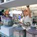 Artist Robin Morris, center, rearranges her ceramic pieces on Friday morning at the Ann Arbor Summer Art Fair on Liberty. Angela J. Cesere | AnnArbor.com 