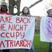 University of Michigan students Matthew Bowers, left, Mary Kate Bachler, center, and Sasha Hoffman hold up signs for the Take Back the Night rally in Ann Arbor. The Take Back the Night rally raises awareness of sexual assault and supports victims. Angela J. Cesere | AnnArbor.com
