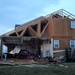 A house on Noble Dr. in Huron Farms neighborhood in Dexter is missing an entire wall and part of the roof after a tornado touched down. Angela J. Cesere | AnnArbor.com
`