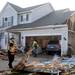 Firemen help clear debris from a yard on Noble St. in Huron Farms after a tornado hit Dexter, Mich. on March 15, 2012. Angela J. Cesere | AnnArbor.com
