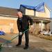  JCG Disaster Restoration employee Mike Hanson sweeps the driveway of Bob Bricault's house after a tornado damaged his house in Huron Farms neighborhood in Dexter, Mich. on March 16, 2012. Angela J. Cesere | AnnArbor.com
